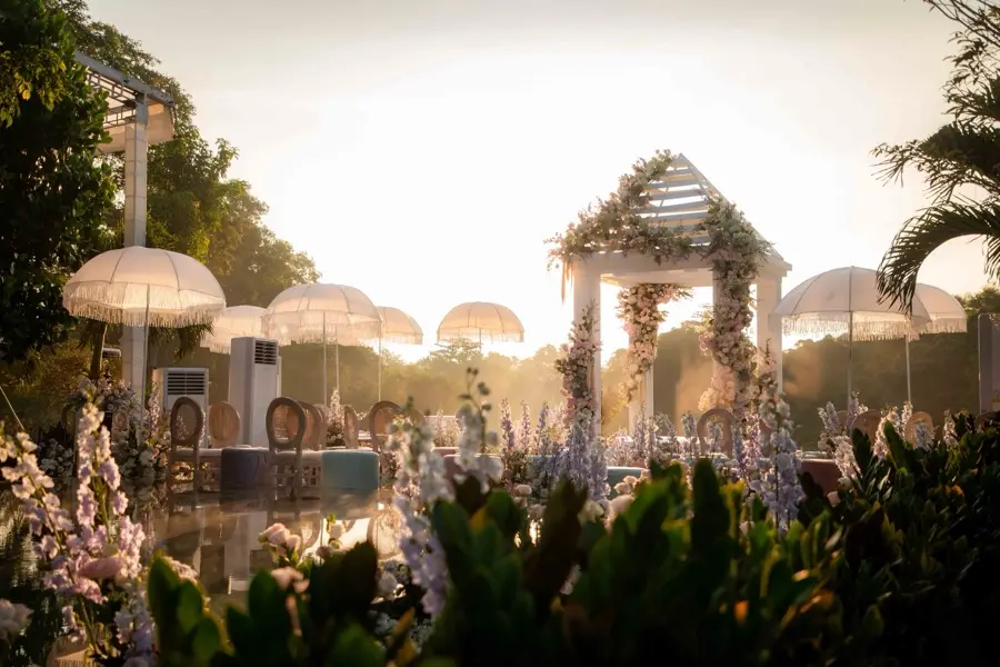 Garden ceremony under parasols at golden hour
